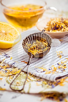 Herbal tea with infuser and cup of tea