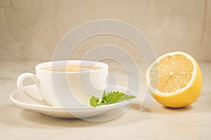 herbal tea with a lemon and mint/herbal tea with a lemon and mint on a white background closeup. Selective focus
