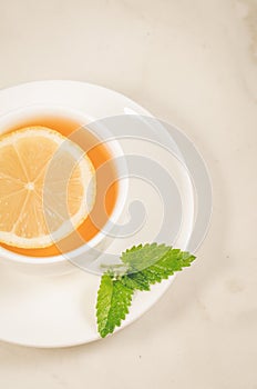 herbal tea with a lemon and mint/herbal tea with a lemon and mint on a white background closeup. Top view