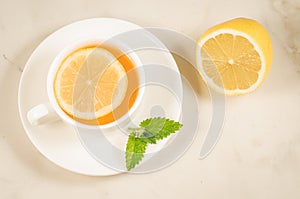 Herbal tea with a lemon and mint/herbal tea with a lemon and mint on a white background. Top view