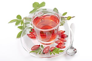Herbal tea made of rose hip with fruits on white background