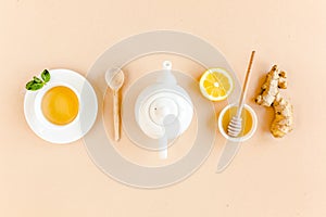 Herbal tea with mint, ginger, lemon, honey and other herbs on yellow background. Flat lay, top view.