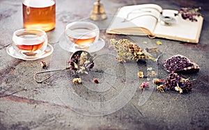 Herbal tea, old book and a watch on a chain