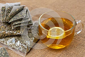 Herbal tea in sachets on burlap background