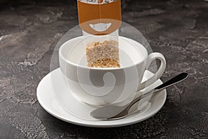 Herbal tea Superfood. Close-up tea bag for brewing in a cup on a black textured background.