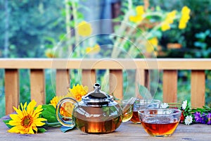 Herbal tea in teapot and cup.