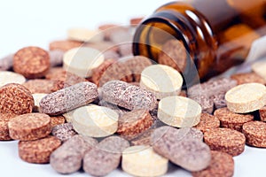 Closeup of herbal vitamin and supplement pills with herbs. photo