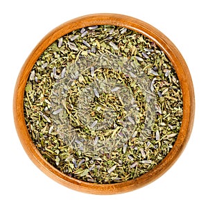 Herbes de Provence in wooden bowl over white