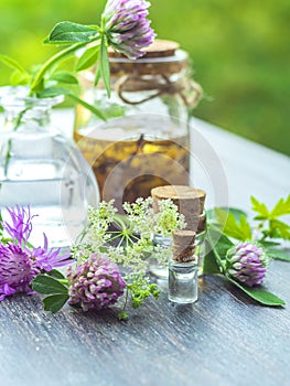 Herbs, bottles on wooden background. Alternative Medicine, Natural Healing