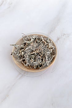 Herbs Iceland moss Cetraria islandica. dry Icelandic moss in a wooden plate on table