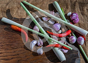 Herbs and ingredient mixed Lemon Grass, Shallot, Garlic, Chili on wooden chopping board