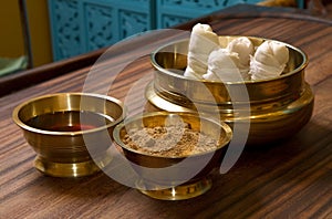 Herbs powder and oil in bronze cups