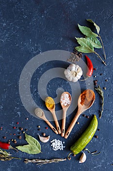 Herbs and spices on black background Food background measuring spoon . spice spoon laurel Copy space