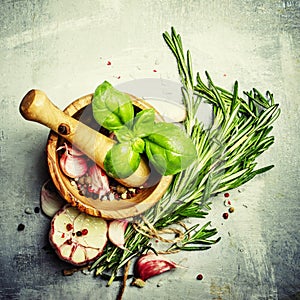 Herbs, spices, garlic and sea salt in a wooden mortar and pestle