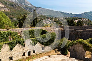 Herceg Novi, Montenegro. Stone houses and walls covered by ivy a