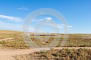 A herd of horses with the drovers on horseback in the steppes of Kazakhstan