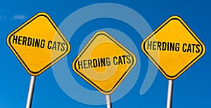 Herding cats - yellow signs with blue sky