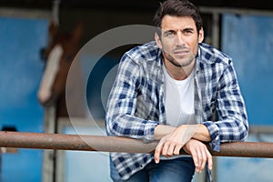 herdsman standing in front cattle in farm