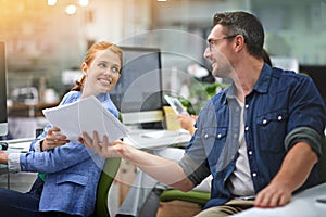 Here we go...a young businesswoman handing some paperwork to a male colleague.