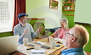 Here are my suggestions. three seniors having a meeting around a table at home.