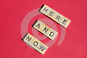 Here and now - the motivating inscription is laid out on a red background with wooden blocks with black letters