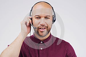 Here to give you the service you deserve. Studio shot of a handsome young male customer service representative wearing a