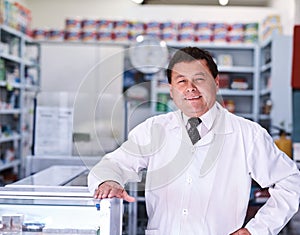 Here to help you get to good health. Portrait of a male pharmacist in a pharmacy.
