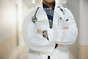 Here to keep you well. an unrecognisable doctor standing in a hospital.