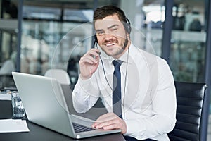 Here to offer support. Portrait of a young customer service representative wearing a headset while sitting at his