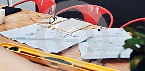 Here visions are turned into reality. Still life shot of a pair of spectacles placed on top an architects blueprints in