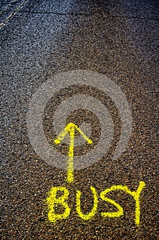 `Busy` Spray Painted on Road - Metaphor to be careful of busyness!