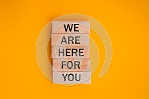 we are here for you, Written on wooden blocks, words to live by, Business idea. invitation to cooperation, support concept,