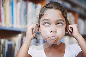 Heres a funny face for you. A cute young girl pulling her ears and making a funny face at you.