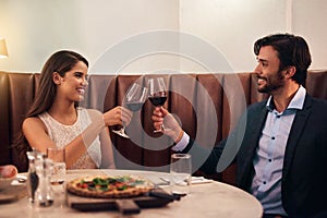Heres to love. a happy young couple enjoying a romantic dinner date at a restaurant.