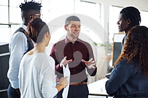 So heres what I think we should do...a group of businesspeople having a discussion in an office.