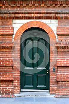 Heritage Arched Door in Red Brick Wall photo