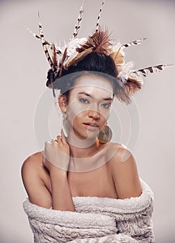 Heritage inspired beauty. A portrait of a young woman in a native american-inspired headdress.