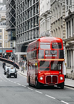 Heritage Routemaster Bus operating in a busy Central London street with traditional black cab on background