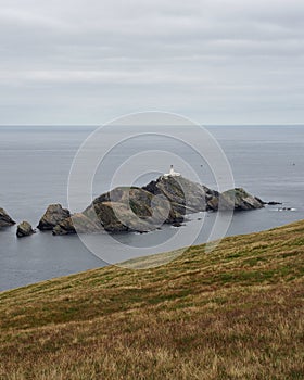 Hermaness National Nature Reserve. View on Muckle Flugga Lighthouse and Out Stack. Unst. Shetland Islands. Scotland photo