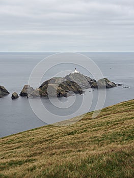 Hermaness National Nature Reserve. View on Muckle Flugga Lighthouse and Out Stack. Unst. Shetland Islands. Scotland photo