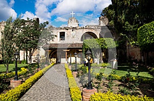 Hermano Pedro garden with green trees and flowers, Antigua, Guatemala photo