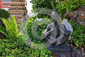 Hermit statue performing Thai yoga
