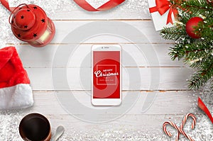 Hero header Christmas scene with mobile phone in the middle wih Merry Christmas message photo