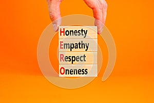 HERO honesty empathy respect oneness symbol. Concept words HERO honesty empathy respect oneness on blocks on beautiful orange