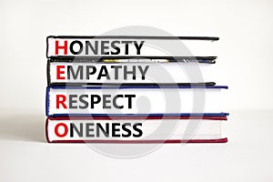 HERO honesty empathy respect oneness symbol. Concept words HERO honesty empathy respect oneness on books on beautiful white