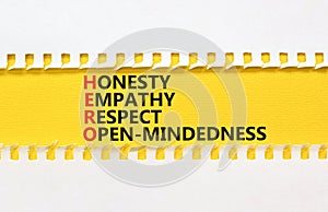 HERO honesty empathy respect open-mindedness symbol. Concept words HERO honesty empathy respect open-mindedness on yellow paper