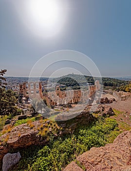 Herodion ancient roman theater under Acropolis hill and Athens city panoramic view.