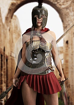 Heroic Spartan female stands ready for battle equipped with a spear and sword.