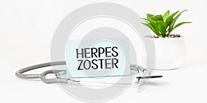 HERPES ZOSTER word on notebook,stethoscope and green plant