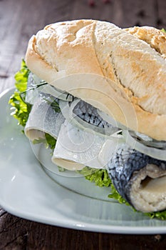 Herring Filet on a baguette (against wood)